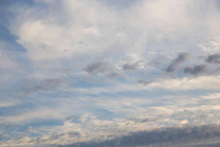blue sky with white clouds of various shapes, sunny day, textureの写真素材