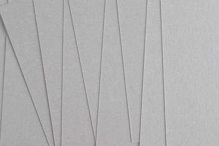 sheets of gray thick paper for business cards, isolate on a black background