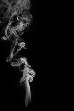 wax candle with burning wick and smoke, isolated on a black backgroundの写真素材