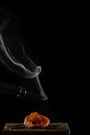 wax candle with burning wick and smoke, isolated on a black backgroundの写真素材
