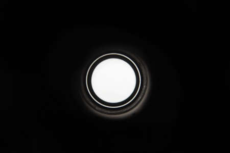 black metal pipe with round illuminated hole, inside viewの写真素材