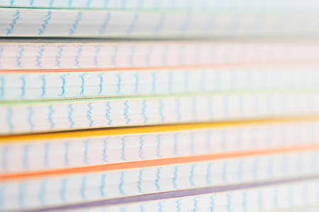 paper school notebooks in a cage are stacked on the tableの写真素材