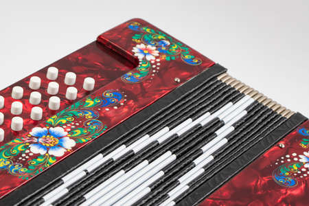 folklore musical instrument, handmade Russian accordion with painting and inlay, isolated on a white backgroundの写真素材