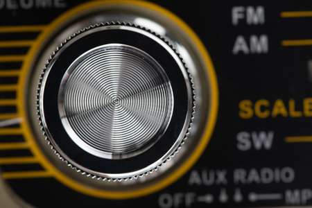 details of a retro-style radio in a brown wooden case, adjustment knobs and a wave scale
