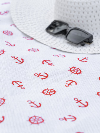 a white waffle beach towel with a red pattern lies folded on the tableの写真素材