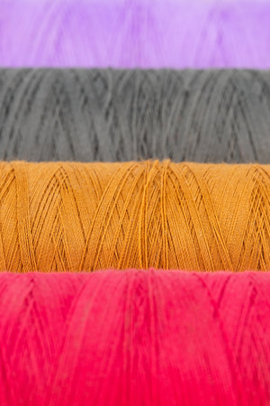 set of multi-colored sewing threads in coils, isolate on a white background