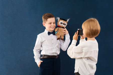 A boy and a girl on the set in the studio for a school albumの写真素材