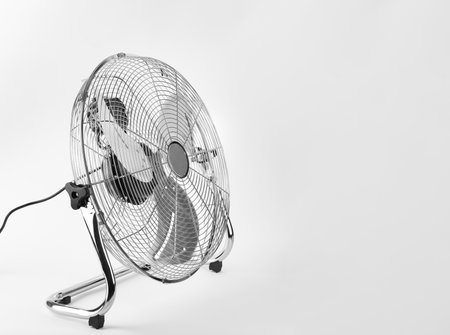 outdoor electric fan with metal safety net, photo on white backgroundの写真素材