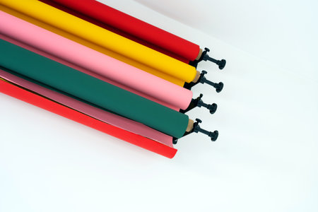 holders for paper roll backgrounds with fan system on a white wall, photo studio