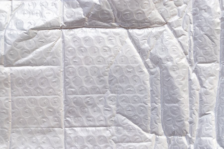 white packaging film with folds and wrinkles, abstract background