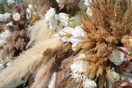 wedding decor for the photo zone, a composition of their white roses and dry grassの写真素材