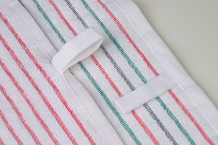 multi-colored striped terry towels for the kitchen with a loop for hanging on a hook, isolatedの写真素材