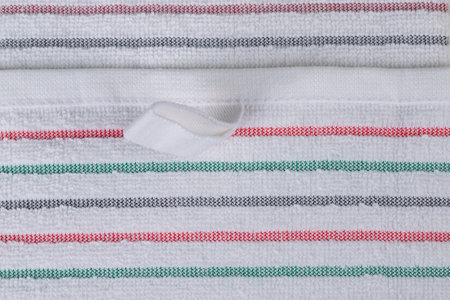 multi-colored striped terry towels for the kitchen with a loop for hanging on a hook, isolatedの写真素材