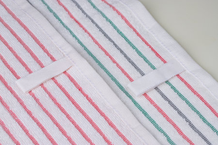 multi-colored striped terry towels for the kitchen with a loop for hanging on a hook, isolatedの写真素材