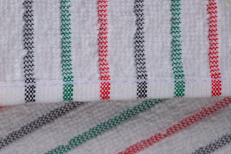multi-colored striped terry towels for the kitchen with a loop for hanging on a hook, isolatedの写真素材