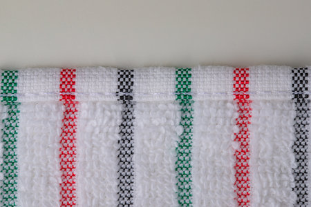 multi-colored striped terry towels for the kitchen with a loop for hanging on a hook, isolatedの写真素材