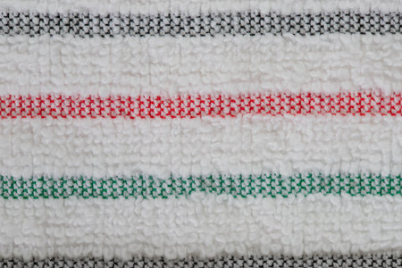 multi-colored striped terry towels for the kitchen with a loop for hanging on a hook, isolatedの写真素材