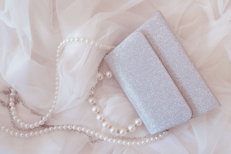 the bride's wedding veil and elegant silver handbag with a chain and pearlsの写真素材