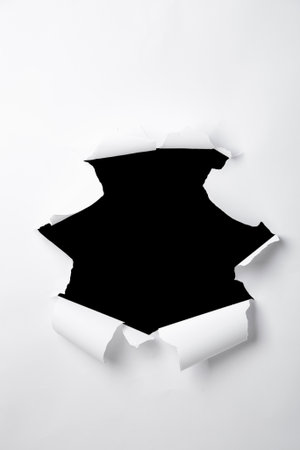 a sheet of paper with a torn hole in the middle in the form of a frame, isolated on a white backgroundの写真素材