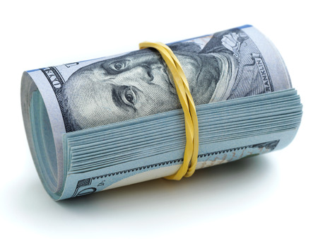 A bundle of one hundred dollars banknotes tied with a rubber band on white background. Business,...