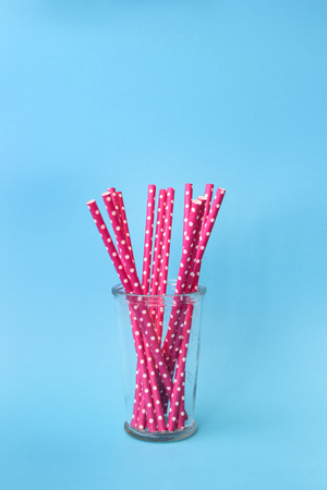 twelve pink straws inside a glass vaseの写真素材