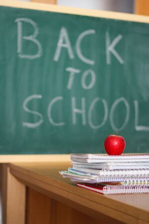 Back to school background with an apple and notebooksの写真素材