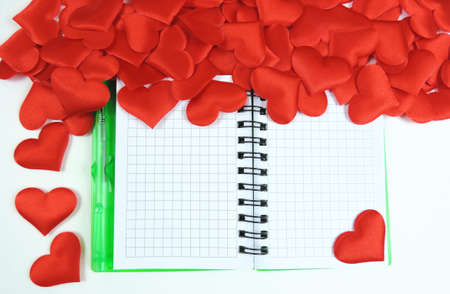 Red hearts and Notepad on white background, Top View . Flat lay