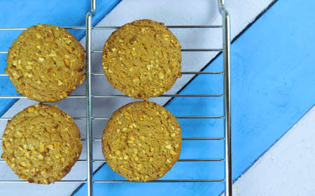 baked oatmeal cookies sprinkled with nuts on a wooden surface
