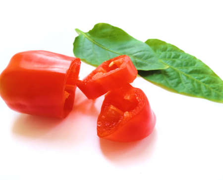red bell pepper and green peppercorn foliage cut on white background