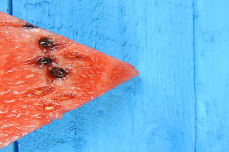 Watermelon slices on blue wooden background. Fruits, freshness, summer conceptの写真素材