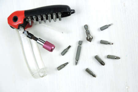 A magnetic quick release bit holder with various screw driving bits and a countersink. white...