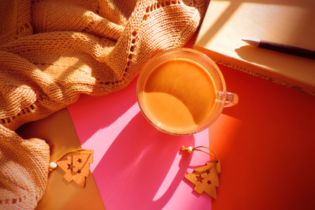 christmas composition, Flat lay with cup of coffee warm plaid notebook pen. Sunset light and...