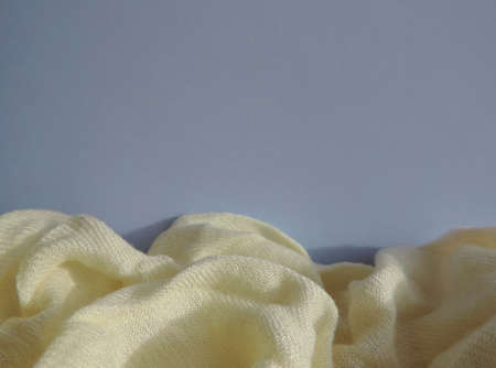 folds of soft beige plaid fabric and gray nude background with place for text, soft sunset lightの写真素材