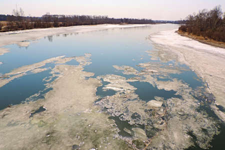 Winter foggy  desert landscape  with starting to freeze  river,   Partly ice covered riverの写真素材