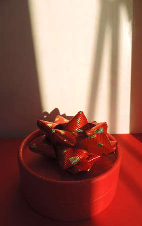 red round gift box and Abstract geometric shadows, sunset light, stripes of light and shadow ,    sunlight patternの写真素材