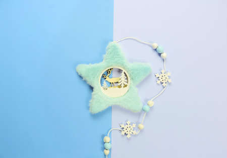 decorative Christmas tree toy pendant with fur trim and carved wooden deer and snowflakes, pastel...