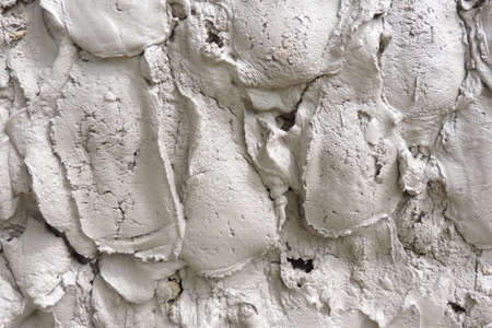 surface drying cement mortar with uneven bumps applied to the wall
