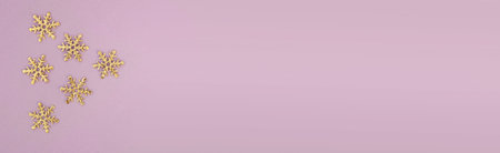 Christmas or winter concept. Frame of golden snowflakes, top view. Layout for greeting card and winter holidays. copy space, banner sizeの写真素材