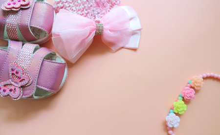 pink girl's bow and beads on pastel pink background, Children's flat lay. children's jewelry and hair accessories, Accessories for little girlsの写真素材