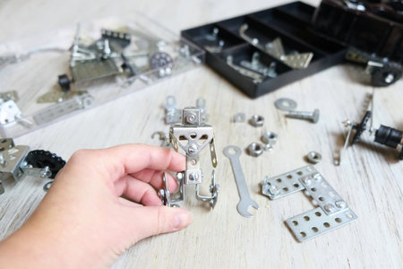 Screw driver, nuts, wrench, bolts and parts of children's metallic constructor. children's metal kit. homeschoolingの写真素材
