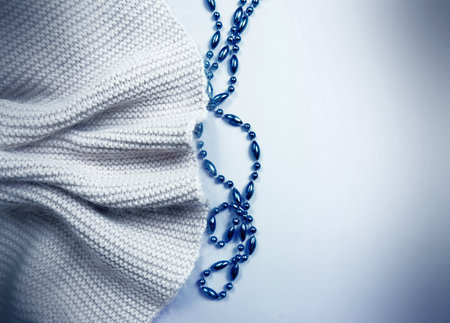 Gray knitted scarf and blue beads flat lay with fogging retro effect. copy spaceの写真素材