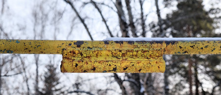 yellow crossbar pole metal, rusty metal texture, deep fracture of metal with peeling paint, Concept...