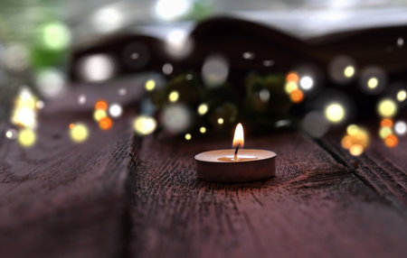 evening dark twilight burning melting candle. decorative blurred festive bokeh. at home, cozy lazy evening time
