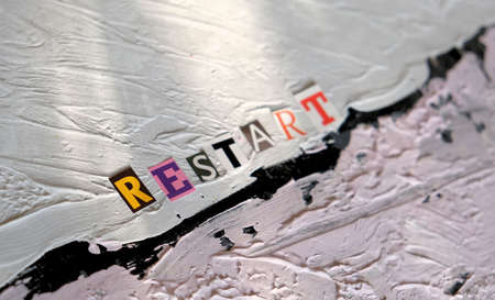 Selective focus of word Restart. inscription on uneven non-uniform putty coating. Text space with...