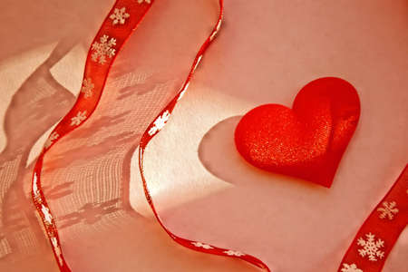 red ribbons with snowflake ornament and red heart, noise and grain retro effect. Fashion shadow...