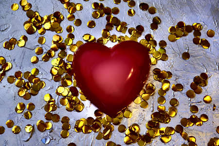 Blurred red heart and golden confetti, retro noise grain effect, tinted, holiday background