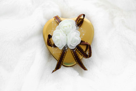 Gift surprise box in heart shape and decoration white flower. White fluffy background. Greeting card for Valentine's Day. Soft style, Copy  space. concept of holiday and love.の写真素材