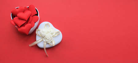 Valentine's day.  White open gift boxe full of decorative festive hearts. Red background. Copy space. Holiday banner, web poster, flyer,  greeting card, cover. Romantic backgroundの写真素材