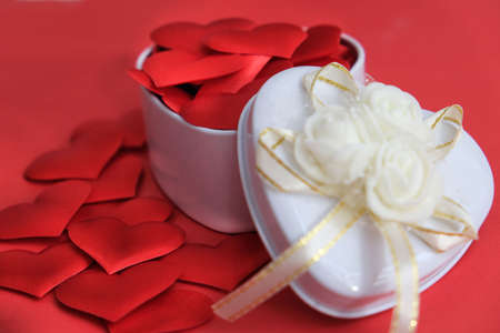 White gift box and red hearts on yred background. Symbol of love, romantic. Concept holiday. Happy...