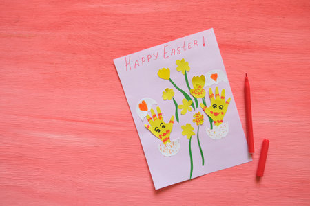Easter funny kids card. Card with Easter eggs and flowers from colorful paper. Handmade. Concept of children's creativity, handicrafts, crafts for kids. Copy spaceの写真素材